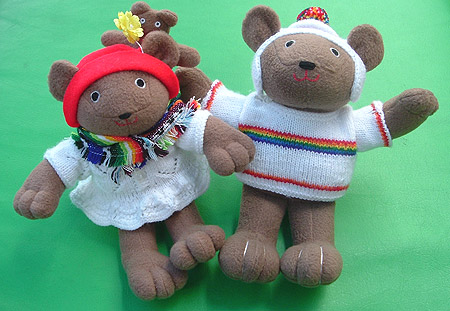 the little bears are wearing rainbow stripes.